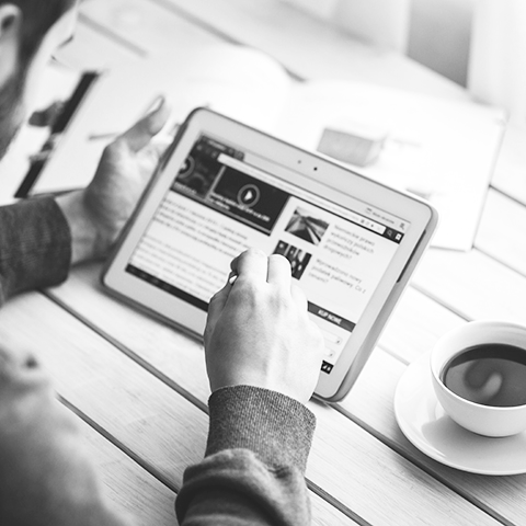 person reading the news on a tablet